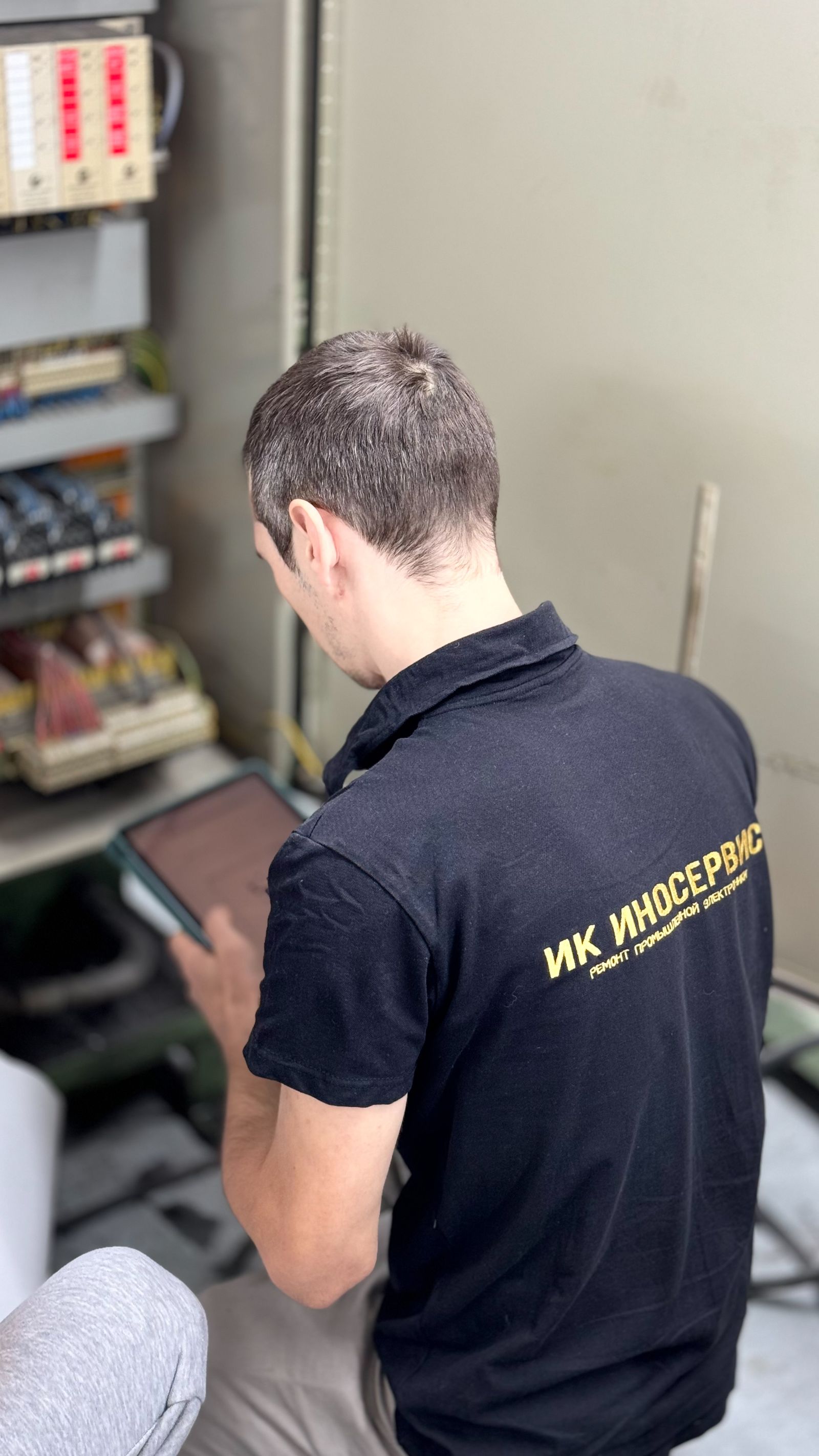 Electrician performing indoor electrical maintenance work
